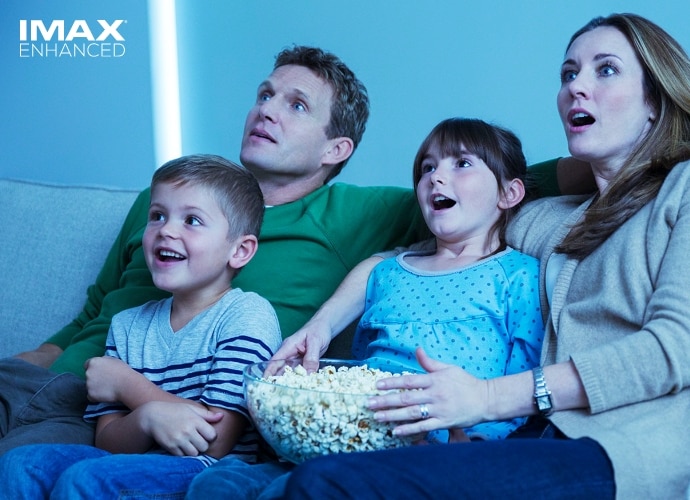 Family enjoying home cinema experience with the VPL-XW7000ES compatible with IMAX Enhanced