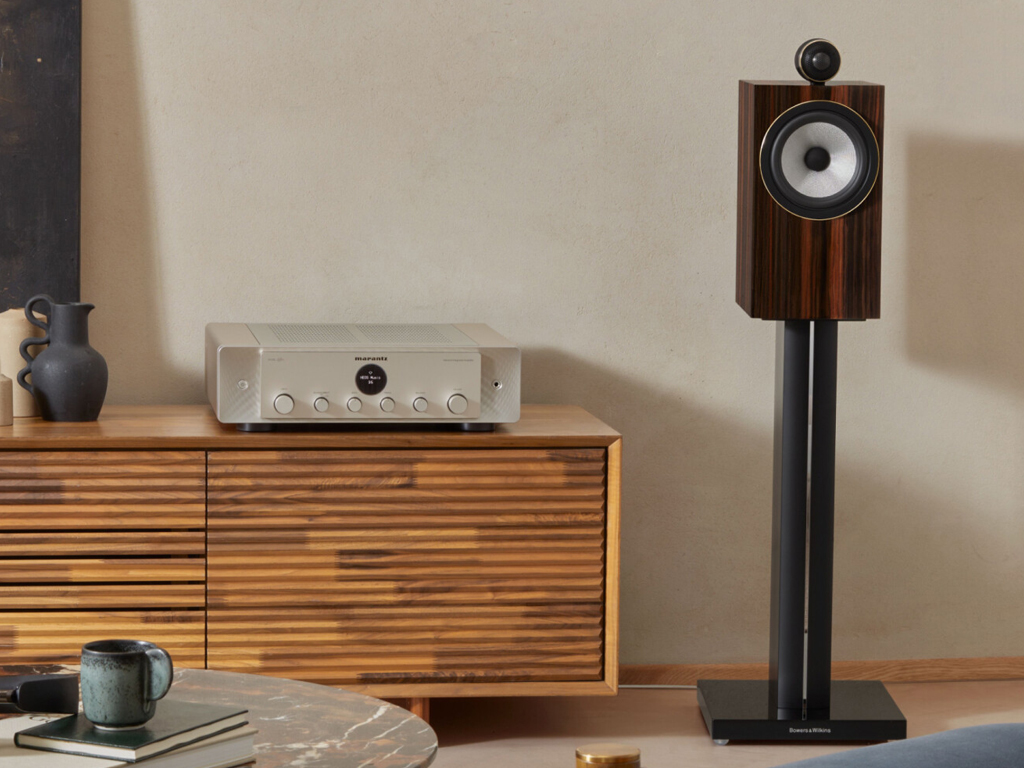 A picture of a bookshelf speaker mounted on a speaker stand